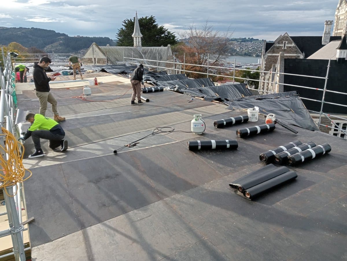 Commercial roofing installation — High-quality membrane installation across a large active worksite. Membrane Roofing Systems, Auckland NZ.